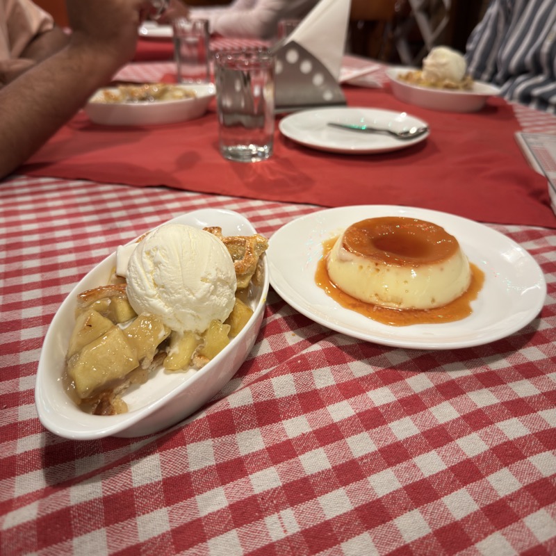 A photo of apple pie with vanilla ice cream and a caramel custurd